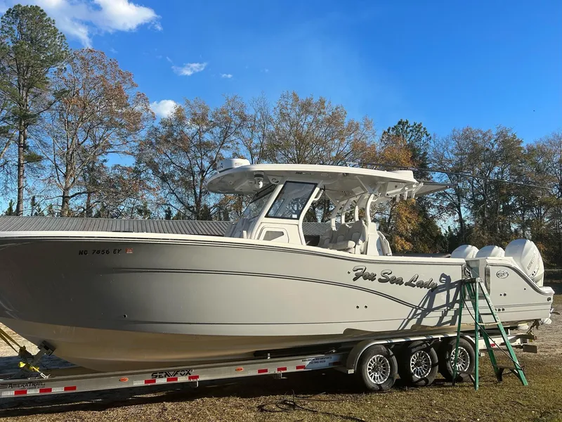 Slide: The Image of 2022 Sea Fox 368 Commander boat on trailer, parked outdoors under clear blue sky. - 4