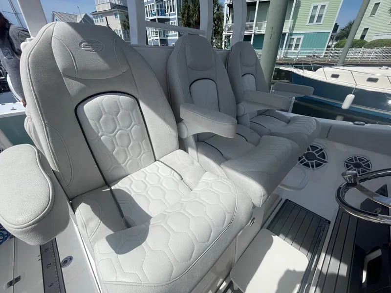 Slide: The Image of Luxurious seating on 2022 Sea Fox 368 Commander boat, featuring plush white upholstery. - 7