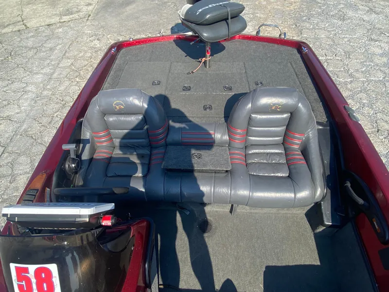 Slide: The Image of 1999 Ranger 519 VX/VS boat interior with dual gray seats and red accents. - 2