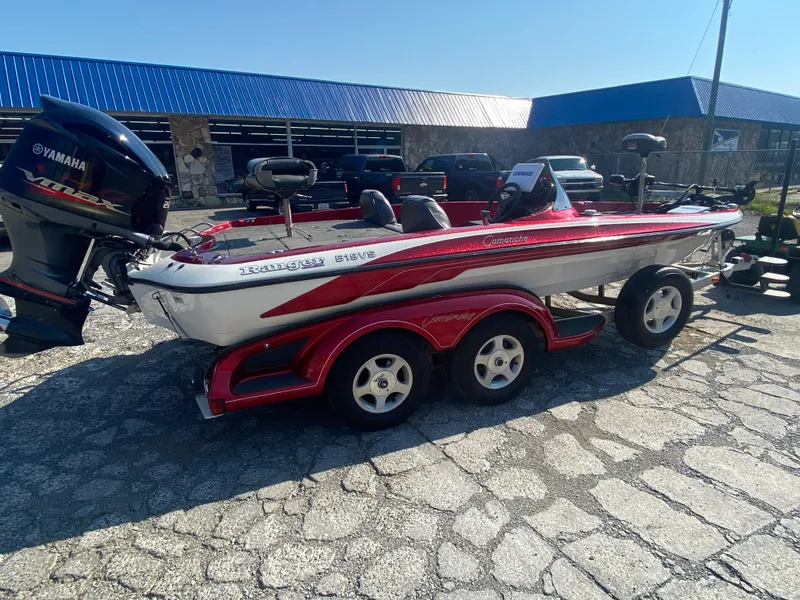 Slide: The Image of 1999 Ranger 519 VX/VS boat with Yamaha motor, parked on a trailer in a lot. - 3