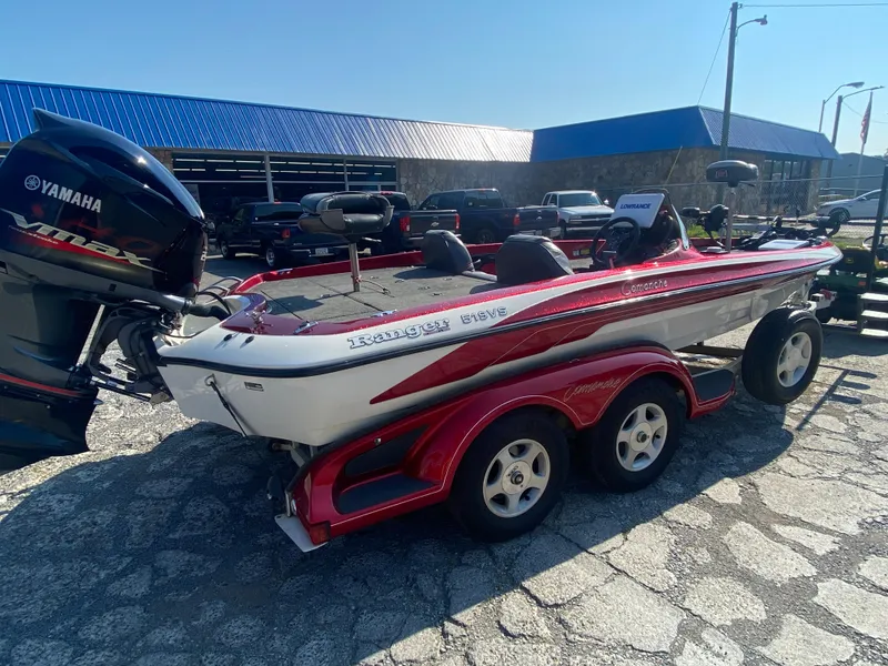 Slide: The Image of 1999 Ranger 519 VX/VS boat with Yamaha VMAX engine, parked outdoors on a sunny day. - 5