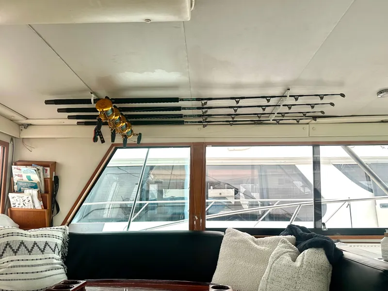 Slide: The Image of Interior of a 1975 Hatteras Sport Fisher with fishing rods and cozy seating. - 11