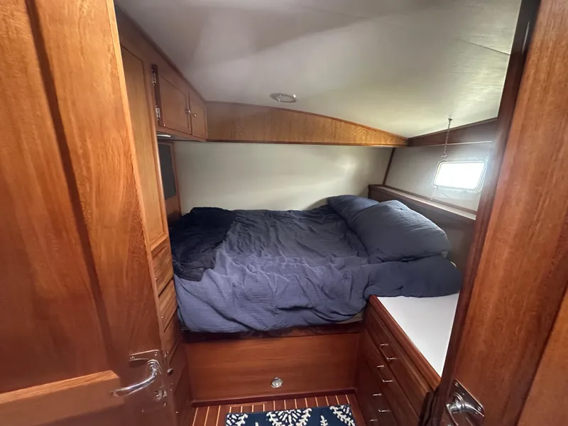 Slide: The Image of 1975 Hatteras Sport Fisher cabin with cozy bed and wooden interior. - 15