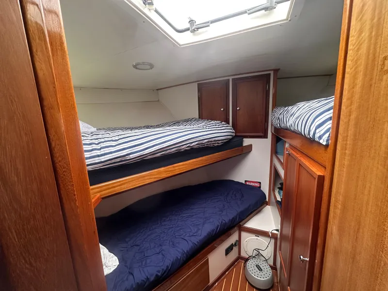 Slide: The Image of 1975 Hatteras Sport Fisher cabin with wooden interior and bunk beds. - 17