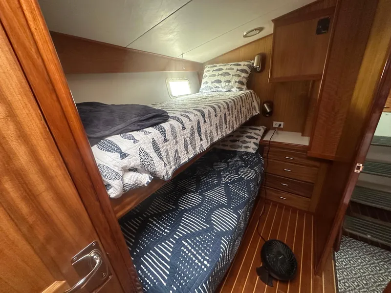 Slide: The Image of 1975 Hatteras Sport Fisher cabin with wooden interior and bunk beds. - 18