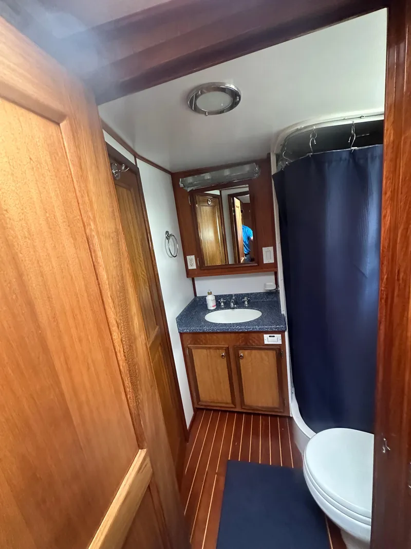 Slide: The Image of Bathroom interior of 1975 Hatteras Sport Fisher yacht with wood accents and shower. - 20