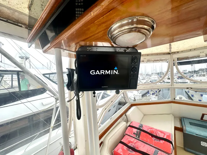 Slide: The Image of 1975 Hatteras Sport Fisher interior with Garmin navigation system, docked at marina. - 26