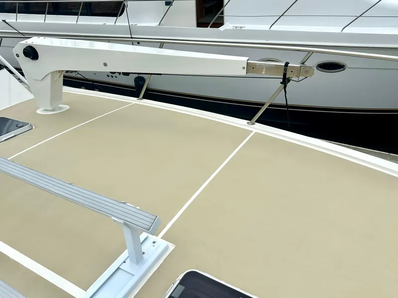 Slide: The Image of 1975 Hatteras Sport Fisher boat deck with railing and winch system. - 36