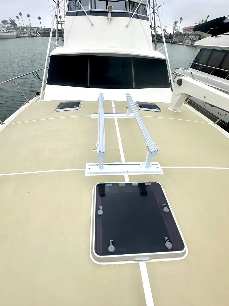 Slide: The Image of 1975 Hatteras Sport Fisher boat deck with hatches, docked in marina. - 37