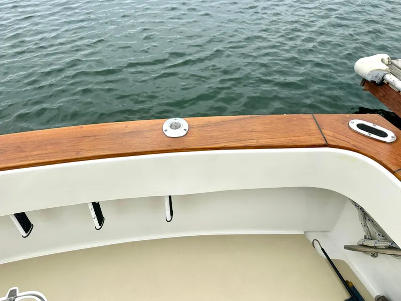 Slide: The Image of 1975 Hatteras Sport Fisher boat deck with wooden railing and ocean view. - 38