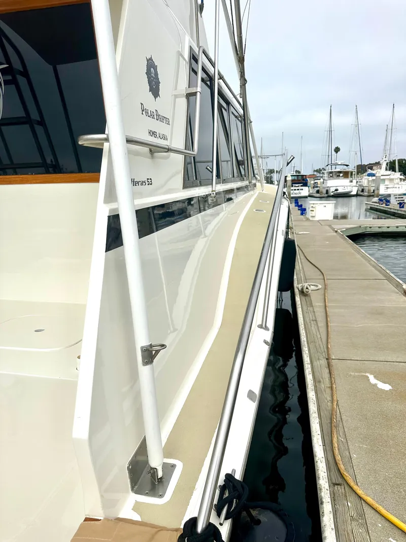 Slide: The Image of 1975 Hatteras Sport Fisher yacht docked at marina, side view. - 39