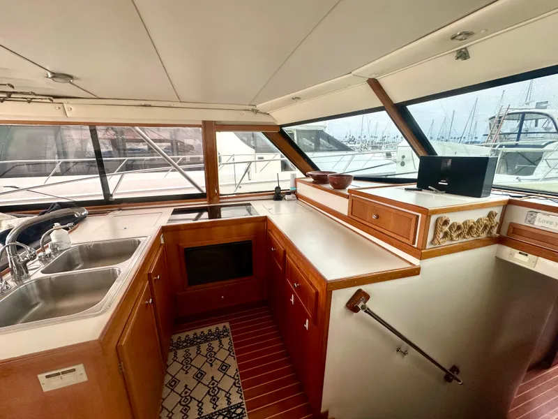 Slide: The Image of Interior of a 1975 Hatteras Sport Fisher yacht with wooden cabinetry and dual sinks. - 4