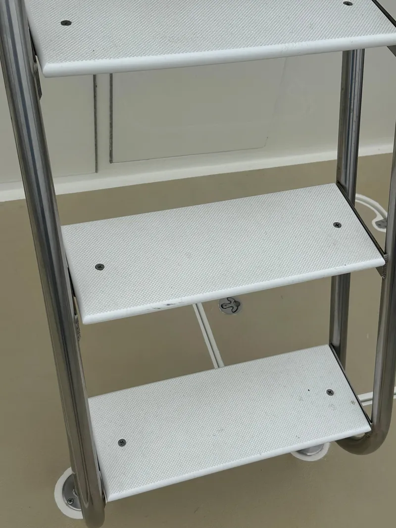 Slide: The Image of Ladder steps on a 1975 Hatteras Sport Fisher boat deck. - 40