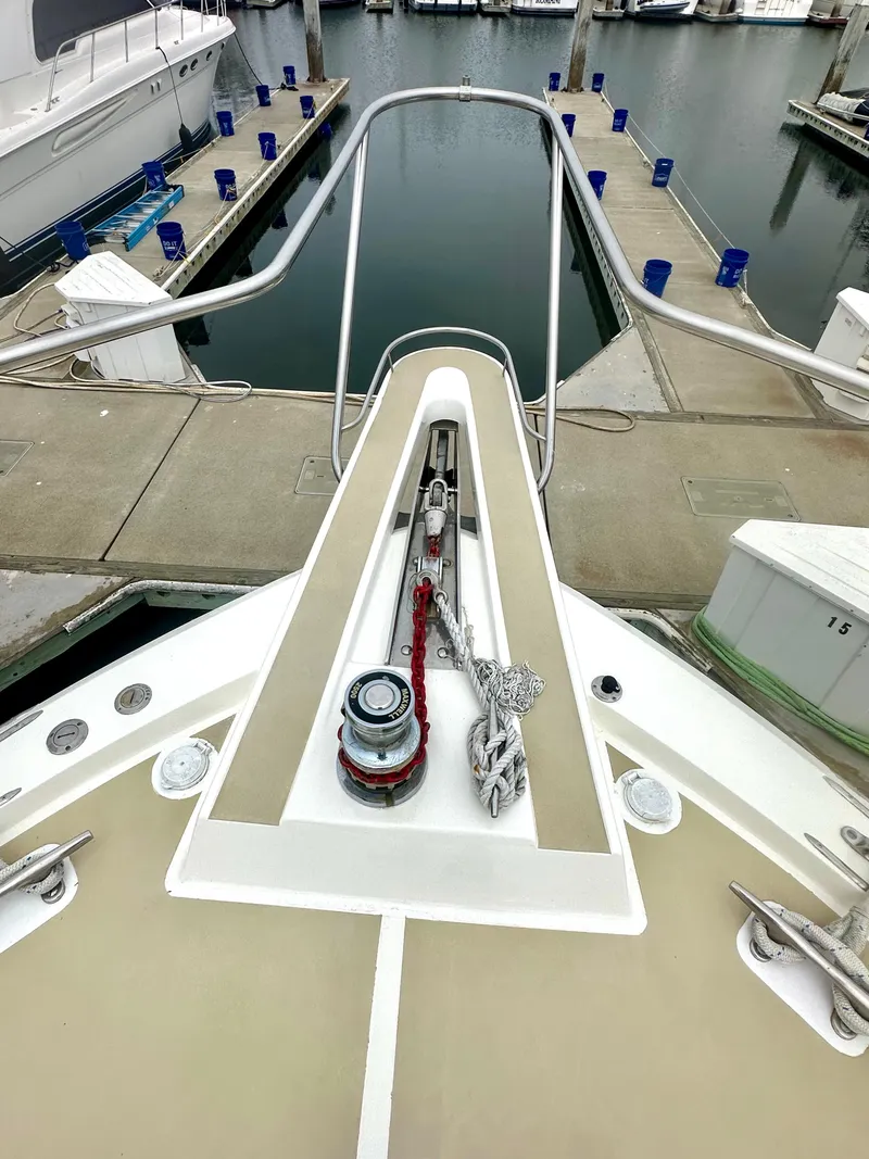 Slide: The Image of Bow view of a 1975 Hatteras Sport Fisher docked at a marina. - 41