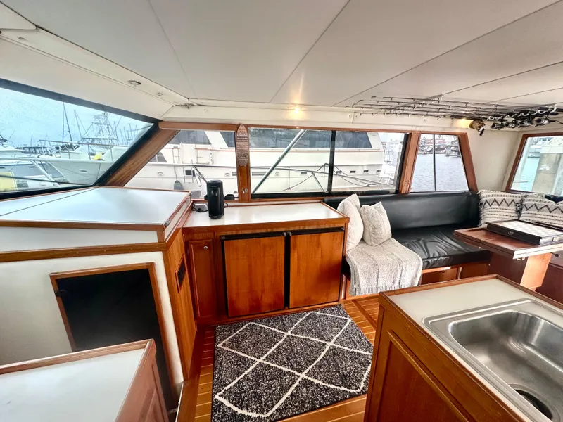 Slide: The Image of Interior of a 1975 Hatteras Sport Fisher yacht with wood cabinetry and seating. - 6