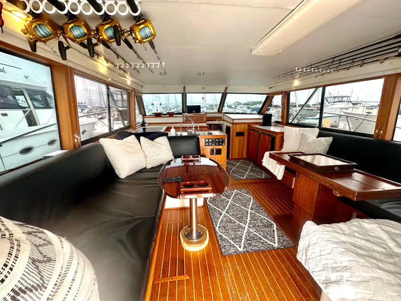 Slide: The Image of Interior of 1975 Hatteras Sport Fisher yacht with wood flooring and fishing rods. - 8
