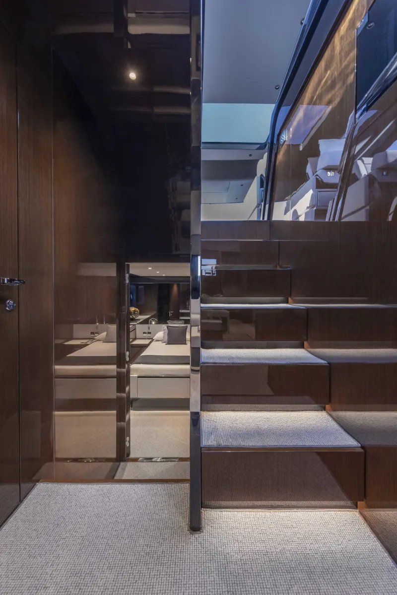 Slide: The Image of Interior staircase of 2026 Riva 68' Diable yacht, featuring sleek wood and modern design. - 16