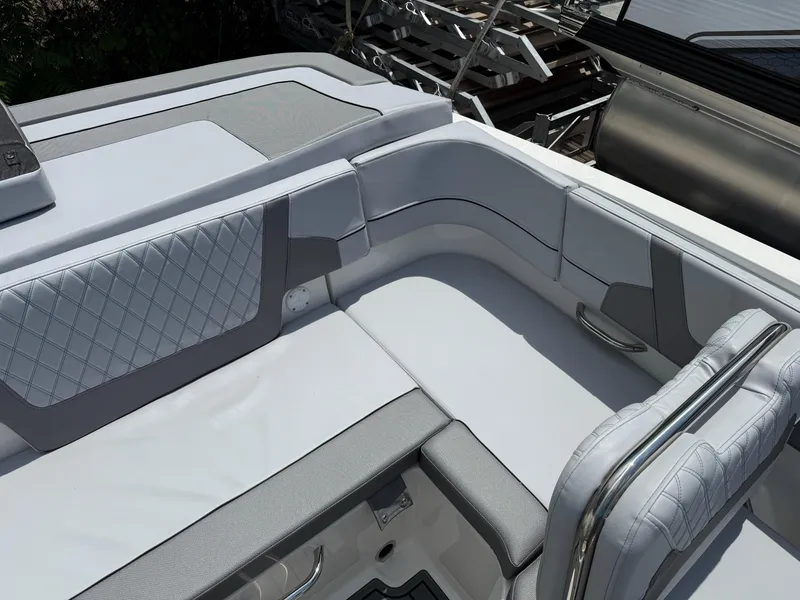 Slide: The Image of 2025 Bayliner VR5 Bowrider I/O interior with sleek, modern seating and quilted upholstery. - 12