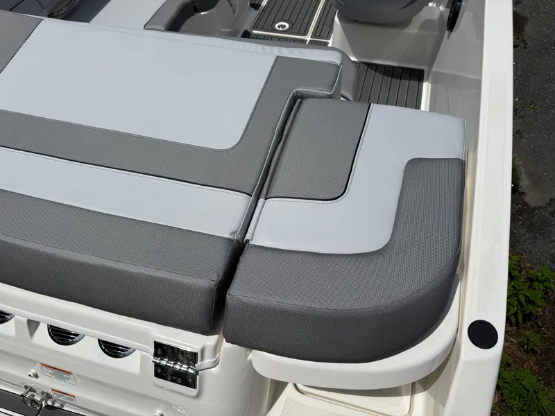 Slide: The Image of 2025 Bayliner VR5 Bowrider I/O boat seating area with gray and white upholstery. - 2
