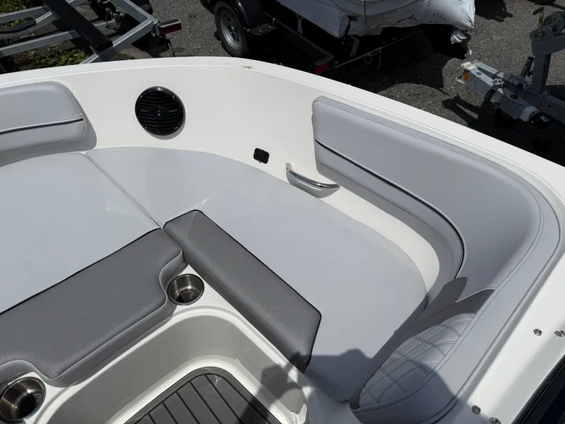 Slide: The Image of 2025 Bayliner VR5 Bowrider I/O interior with cushioned seating and cup holders. - 9