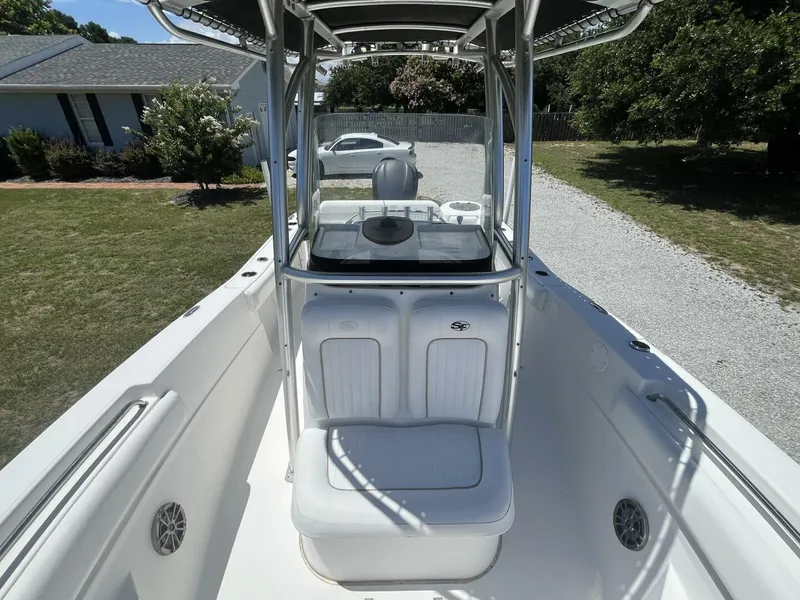 Slide: The Image of 2014 Sea Fox COMMANDER boat with seating and console, parked on gravel driveway. - 17