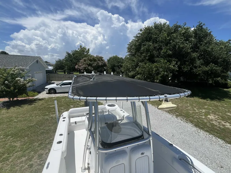 Slide: The Image of 2014 Sea Fox COMMANDER boat with canopy, parked in a grassy yard under a blue sky. - 20