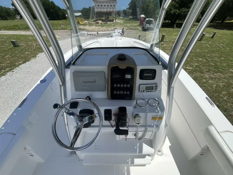 Slide: The Image of 2014 Sea Fox COMMANDER boat console with Garmin navigation, steering wheel, and control panel. - 24