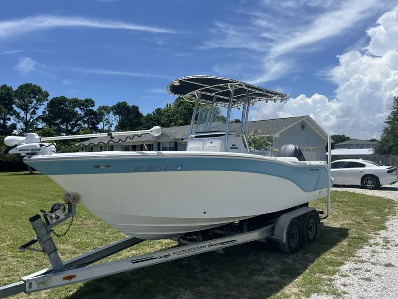 Slide: The Image of 2014 Sea Fox COMMANDER boat on trailer, parked in a grassy yard under a clear blue sky. - 3