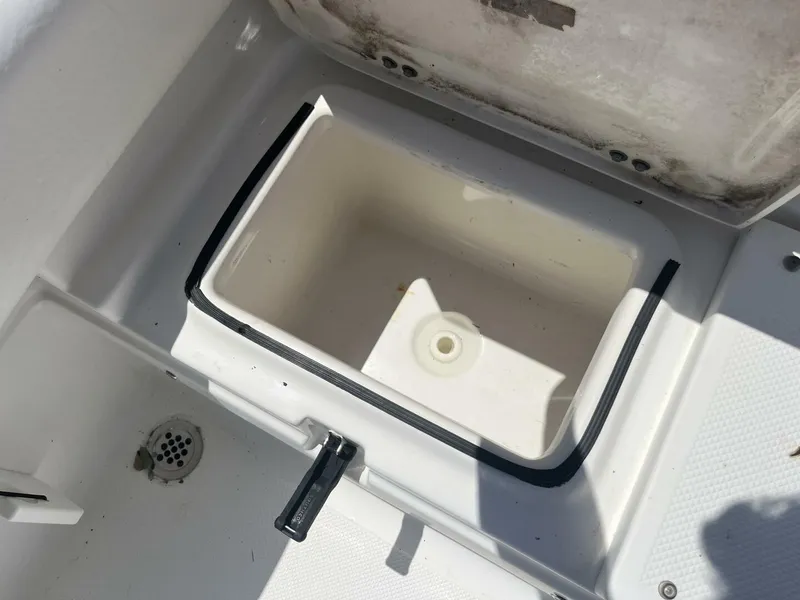 Slide: The Image of Open storage compartment on a 2014 Sea Fox COMMANDER boat, showing interior details. - 30