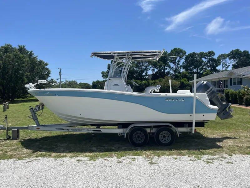 Slide: The Image of 2014 Sea Fox COMMANDER boat on trailer, parked outdoors under clear blue sky. - 4