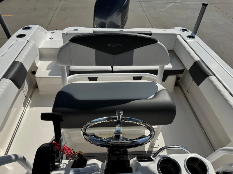 Slide: The Image of 2023 Robalo R202 Explorer boat interior with steering wheel and seating. - 13