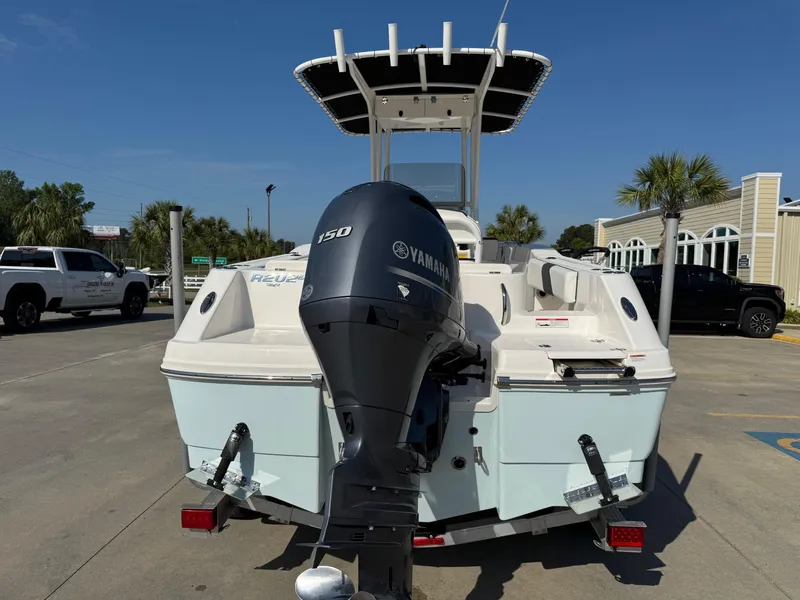 Slide: The Image of 2023 Robalo R202 Explorer boat with Yamaha 150 engine, parked outdoors. - 3
