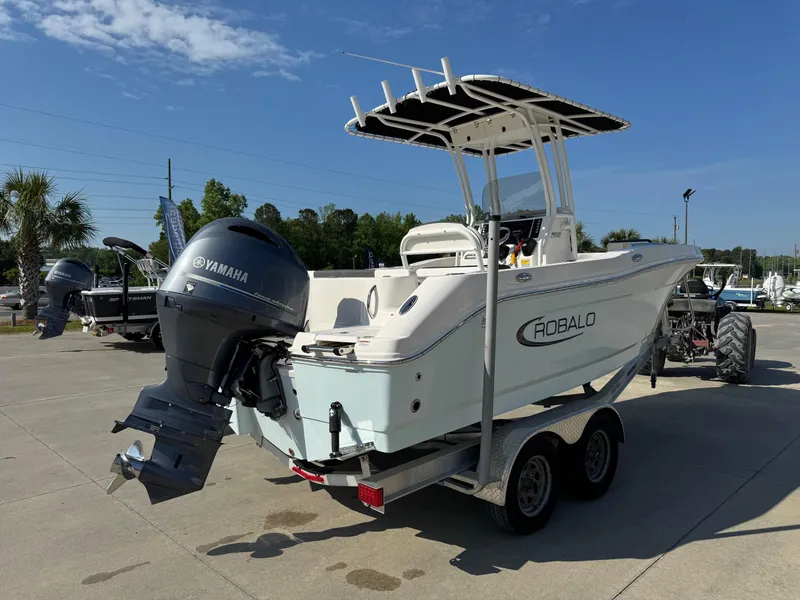 Slide: The Image of 2023 Robalo R202 Explorer boat with Yamaha engine on trailer, parked outdoors. - 4