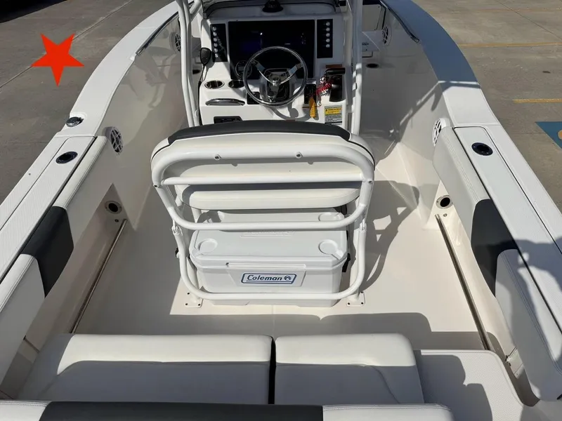 Slide: The Image of 2023 Robalo R202 Explorer boat interior with steering console and seating. - 6