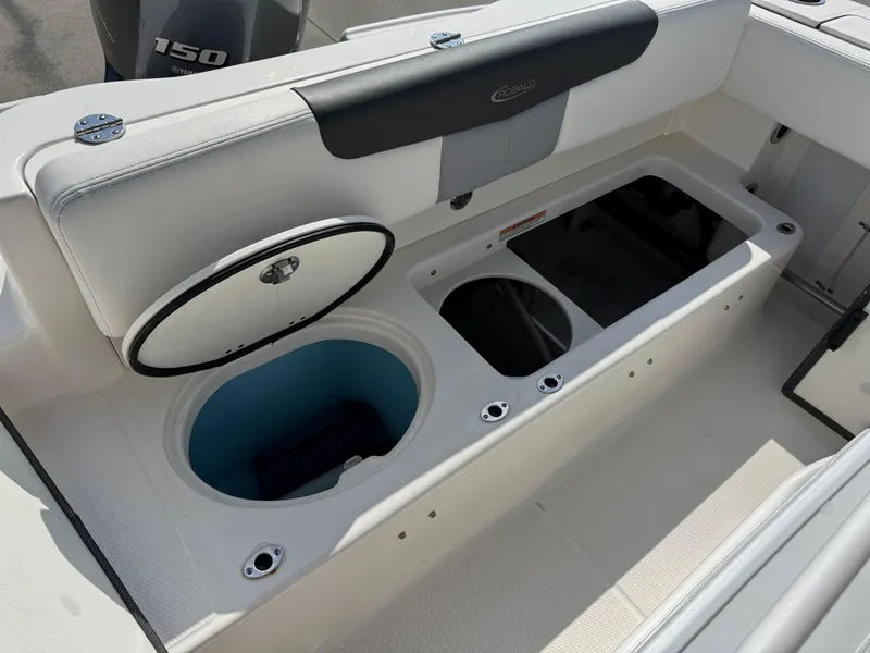Slide: The Image of 2023 Robalo R202 Explorer boat interior with storage compartments and Yamaha 150 engine. - 7