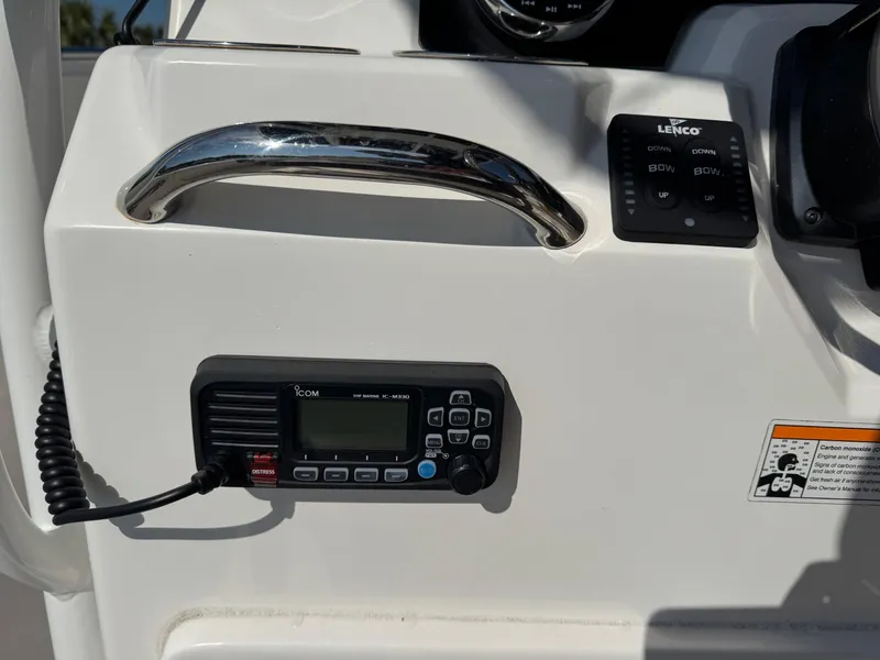 Slide: The Image of 2023 Robalo R202 Explorer dashboard with marine radio and control panel. - 8