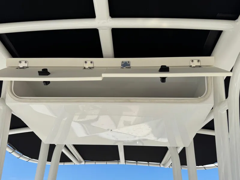 Slide: The Image of 2023 Robalo R202 Explorer boat storage compartment under T-top. - 9