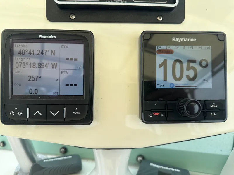 Slide: The Image of Raymarine navigation displays on a 1978 Bertram 33 Convertible boat dashboard. - 11