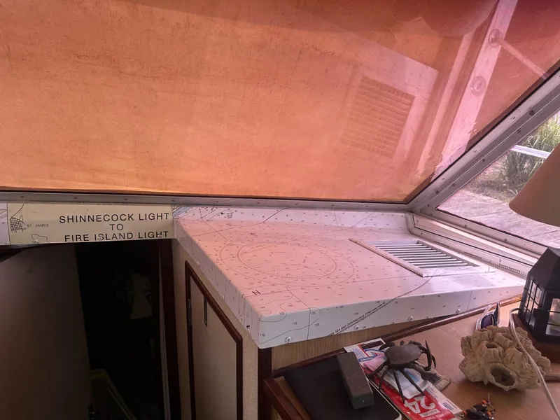 Slide: The Image of Interior of a 1978 Bertram 33 Convertible with nautical chart and decor. - 19