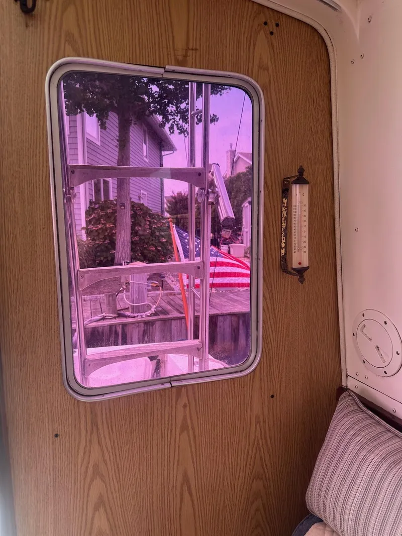 Slide: The Image of Interior view of 1978 Bertram 33 Convertible boat with window and American flag outside. - 20