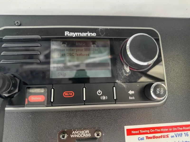 Slide: The Image of Raymarine marine radio on 1978 Bertram 33 Convertible, displaying MMSI entry prompt. - 26