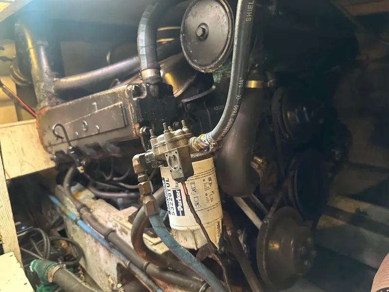 Slide: The Image of Engine compartment of a 1978 Bertram 33 Convertible boat, showcasing mechanical components. - 27