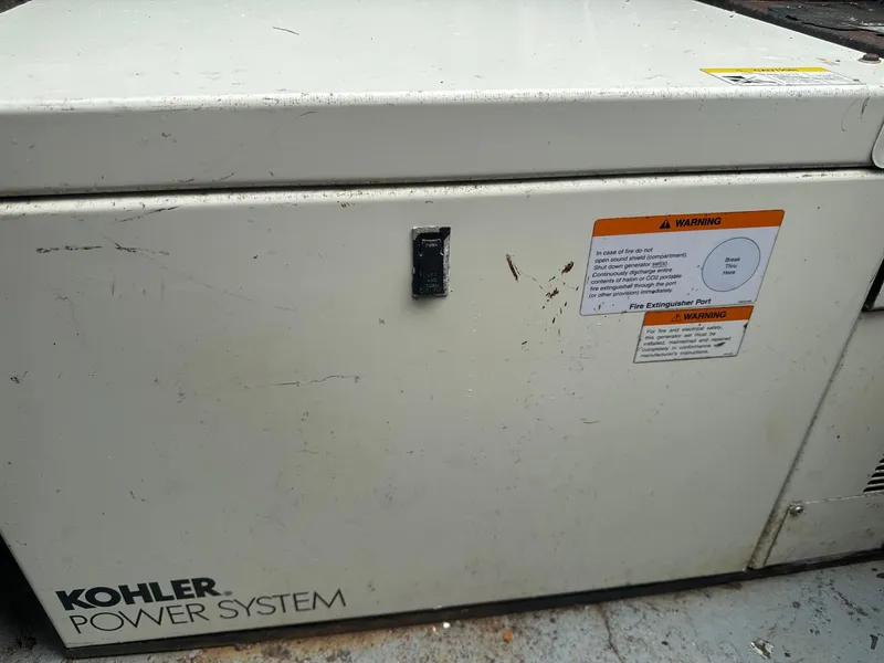 Slide: The Image of Kohler power system on a 1978 Bertram 33 Convertible boat with warning labels. - 29