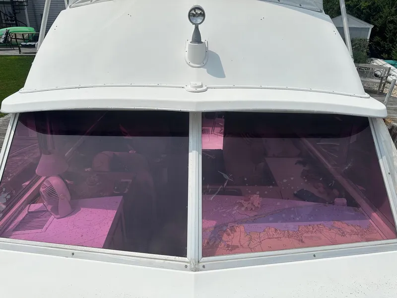 Slide: The Image of 1978 Bertram 33 Convertible boat with tinted windows and interior navigation charts. - 7