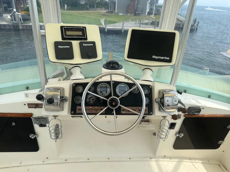 Slide: The Image of 1978 Bertram 33 Convertible helm with Raymarine electronics and classic steering wheel. - 9