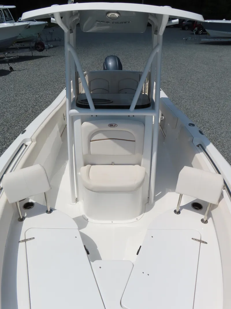 Slide: The Image of 2020 Sea Hunt Ultra 234 boat interior with seating and console, displayed outdoors. - 14