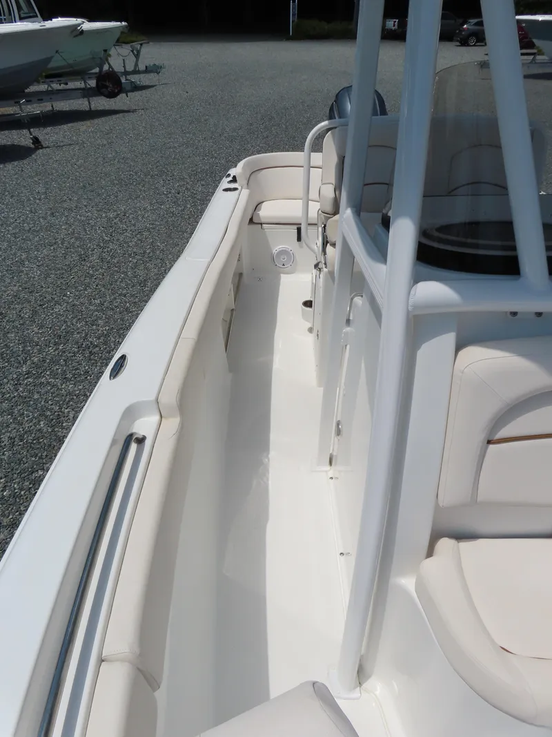Slide: The Image of 2020 Sea Hunt Ultra 234 boat interior with white seating and console. - 15