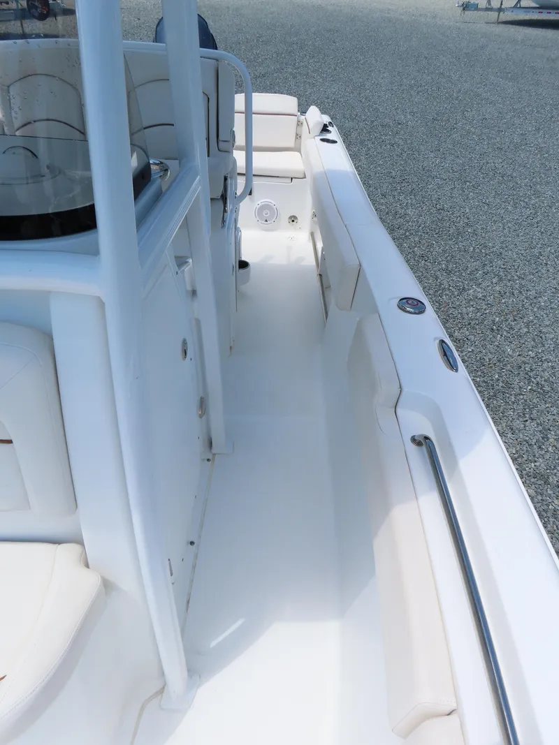 Slide: The Image of 2020 Sea Hunt Ultra 234 boat interior with white seating and console. - 16