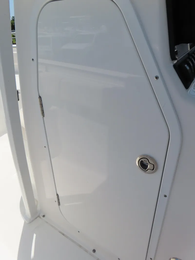 Slide: The Image of White door on a 2020 Sea Hunt Ultra 234 boat, featuring a sleek design and handle. - 19