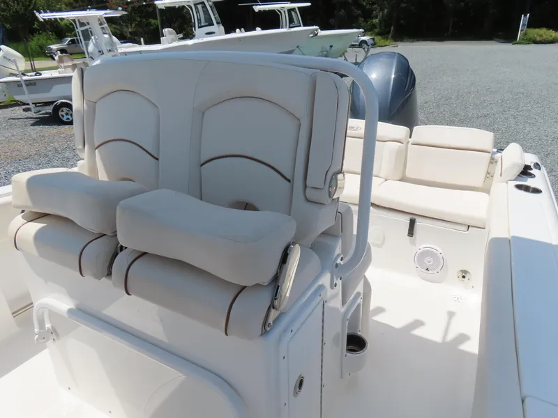 Slide: The Image of 2020 Sea Hunt Ultra 234 boat interior with cushioned seating and console. - 21